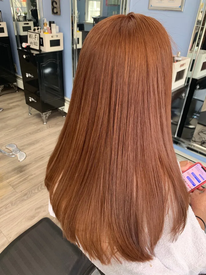 Shoulder-length copper hair, blown out straight