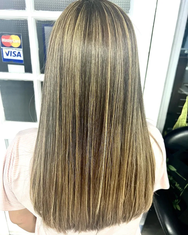 Sleek straight brown hair with blonde highlights